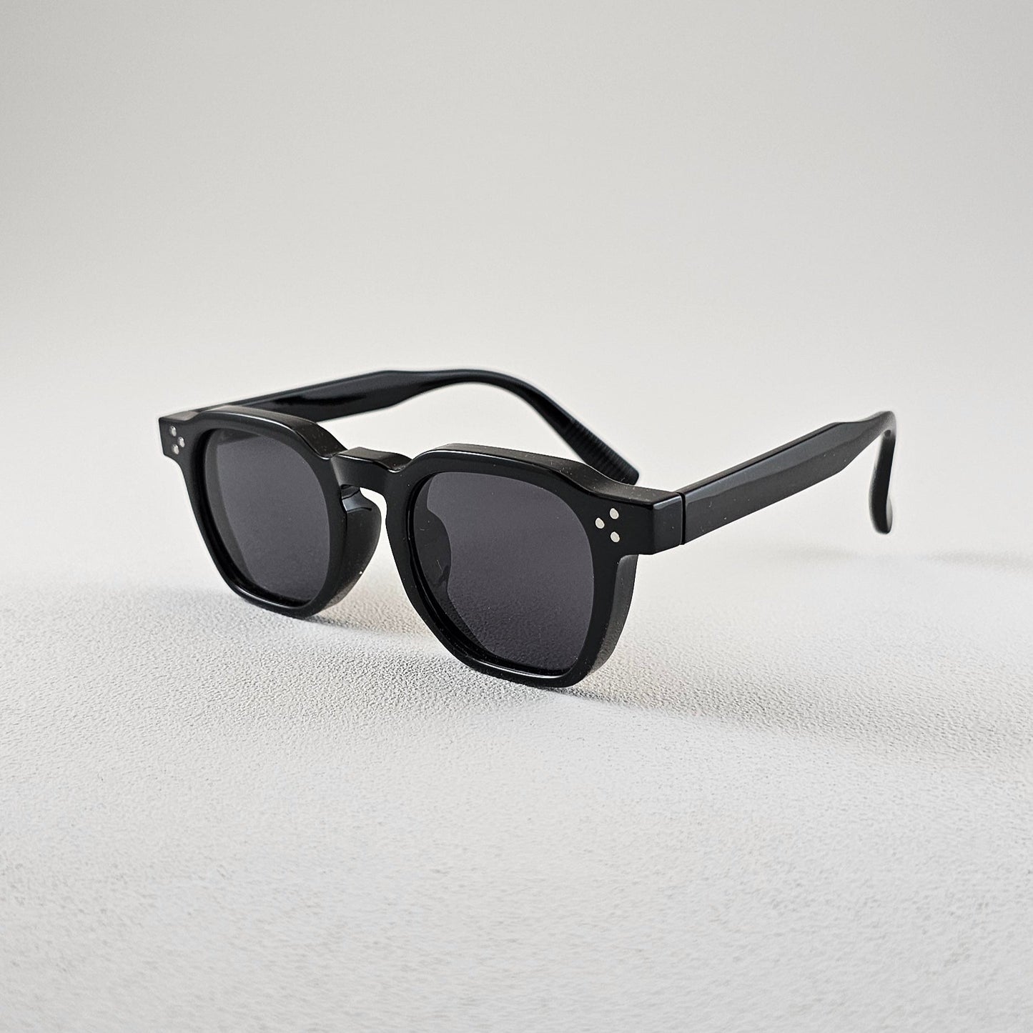 Geometric polarized sunglasses with UV protection – angled view black plastic frame