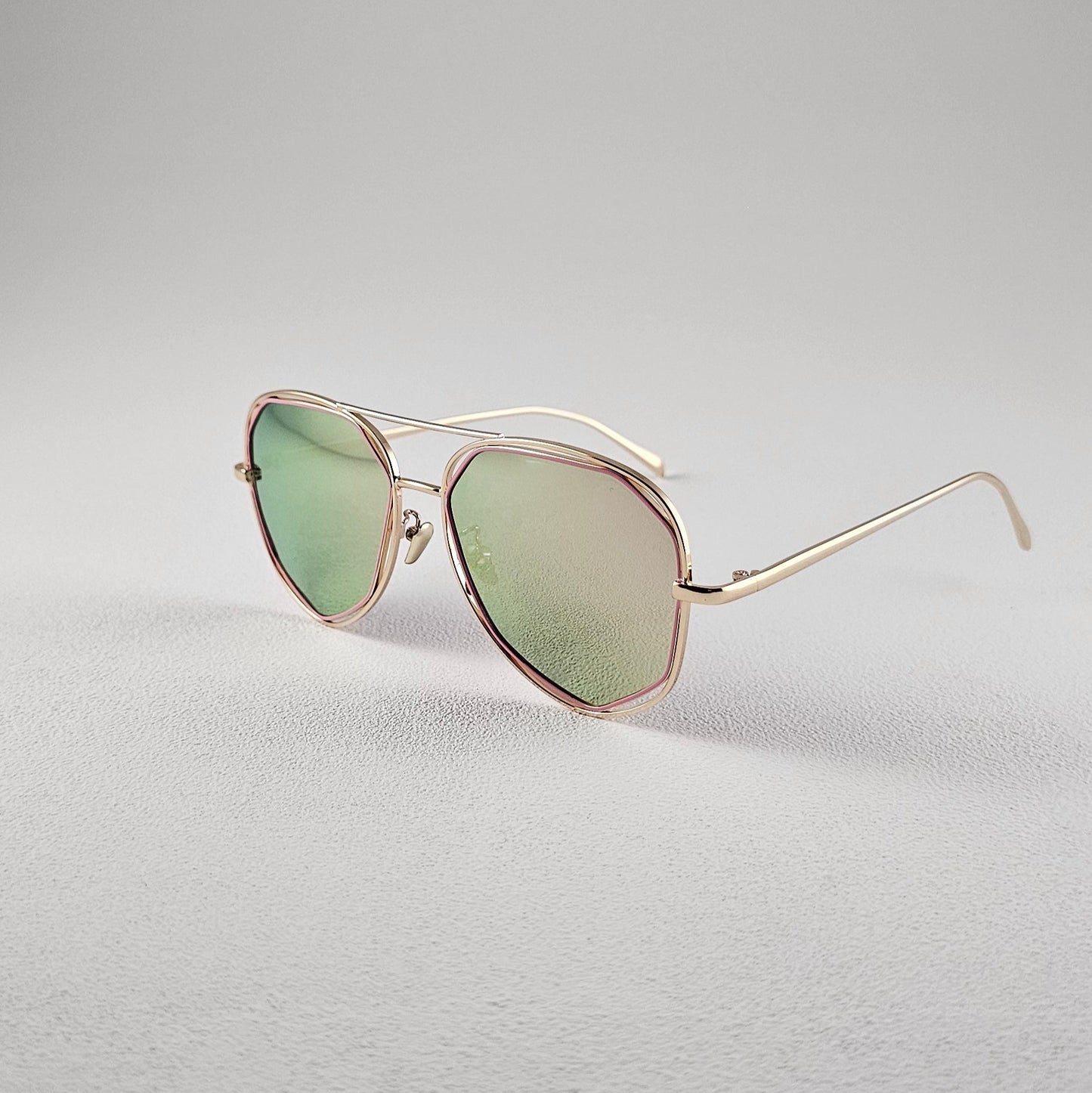 Angled view pink polarized geometric sunglasses with PC lenses and UV protection