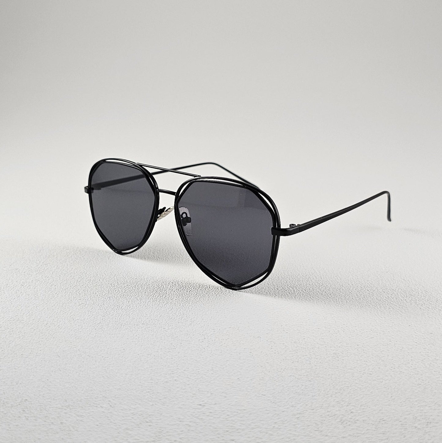 Angled view black polarized geometric sunglasses with PC lenses and UV protection