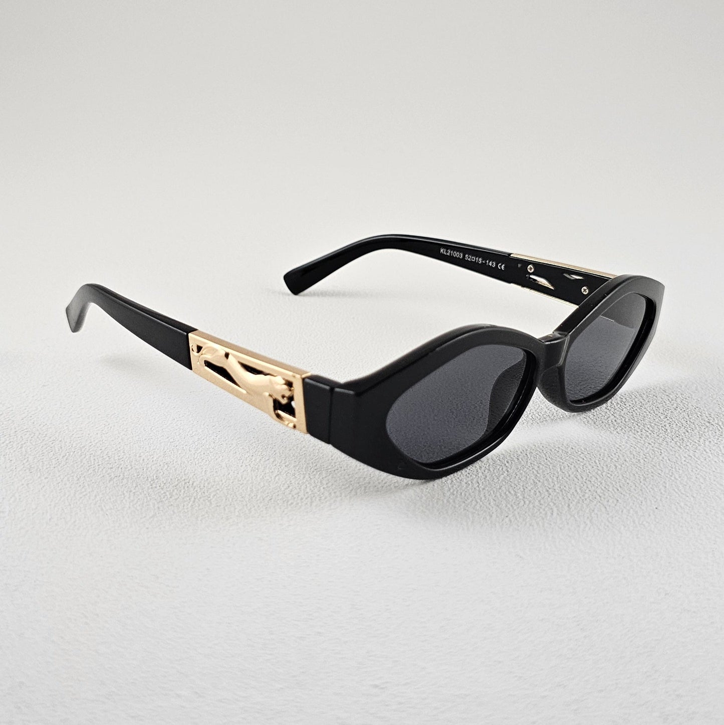 Women's Angela oval sunglasses side view black frame gold detail UV400 lenses
