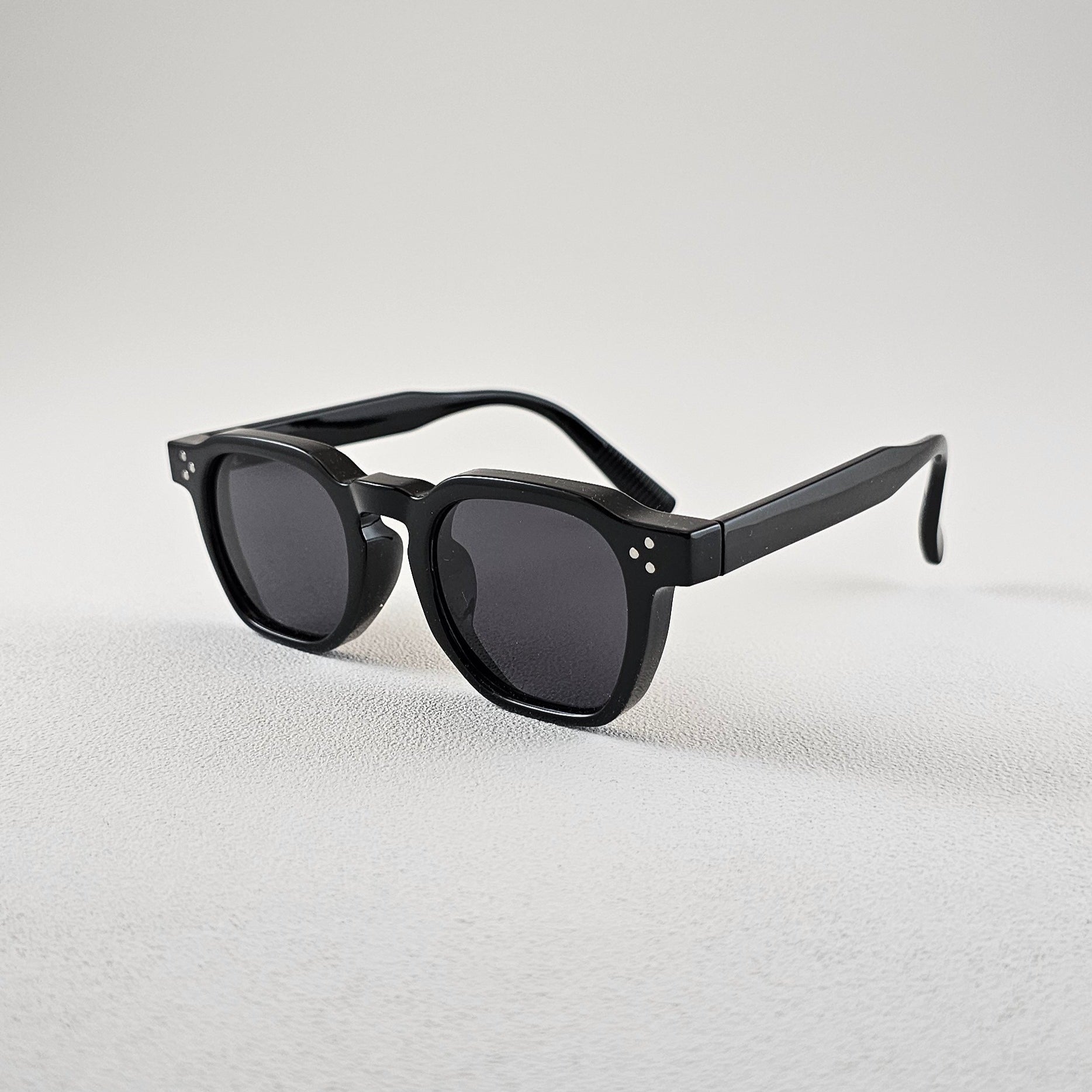 Geometric polarized sunglasses with UV protection – angled view black plastic frame