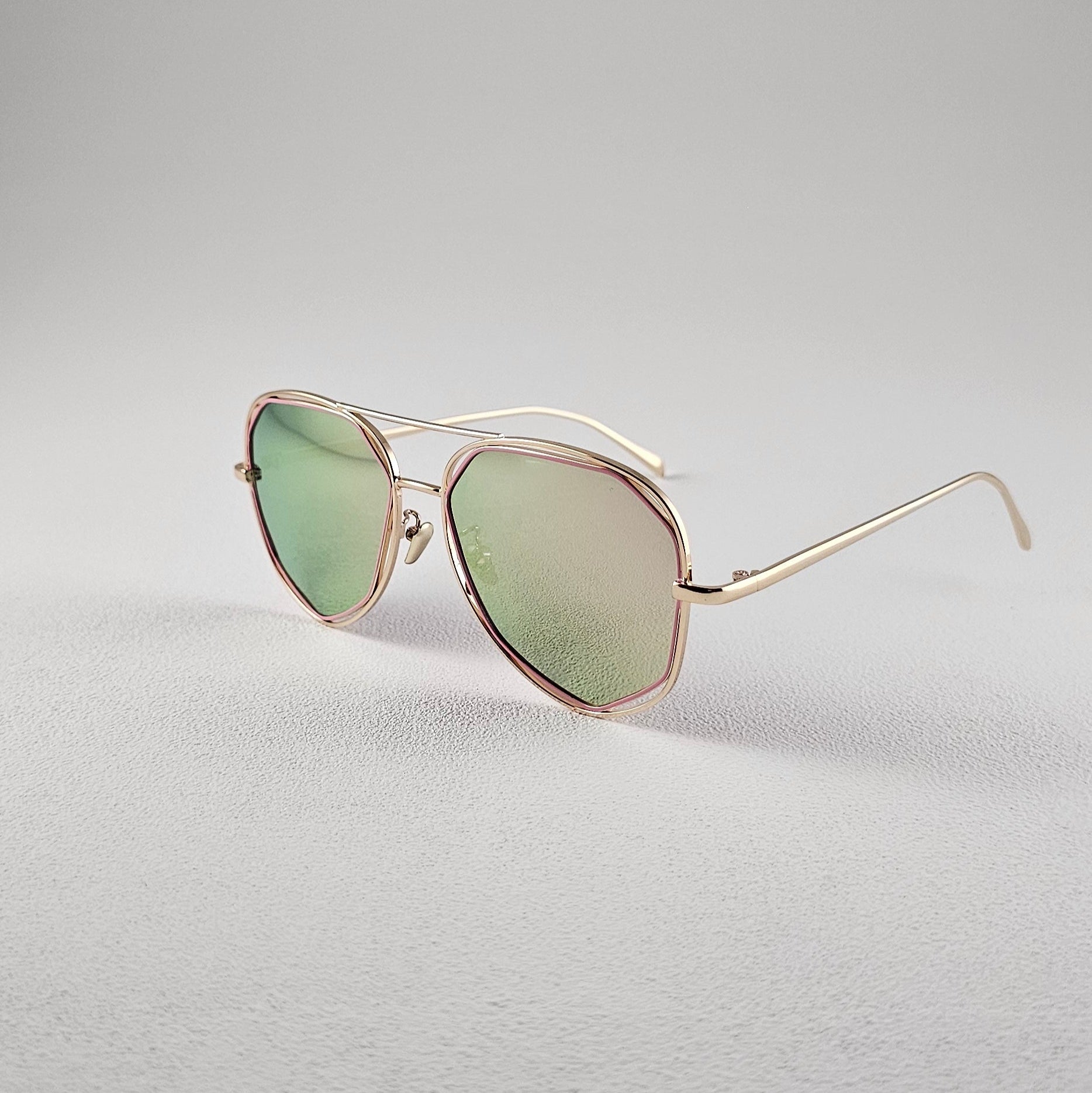 Angled view pink polarized geometric sunglasses with PC lenses and UV protection